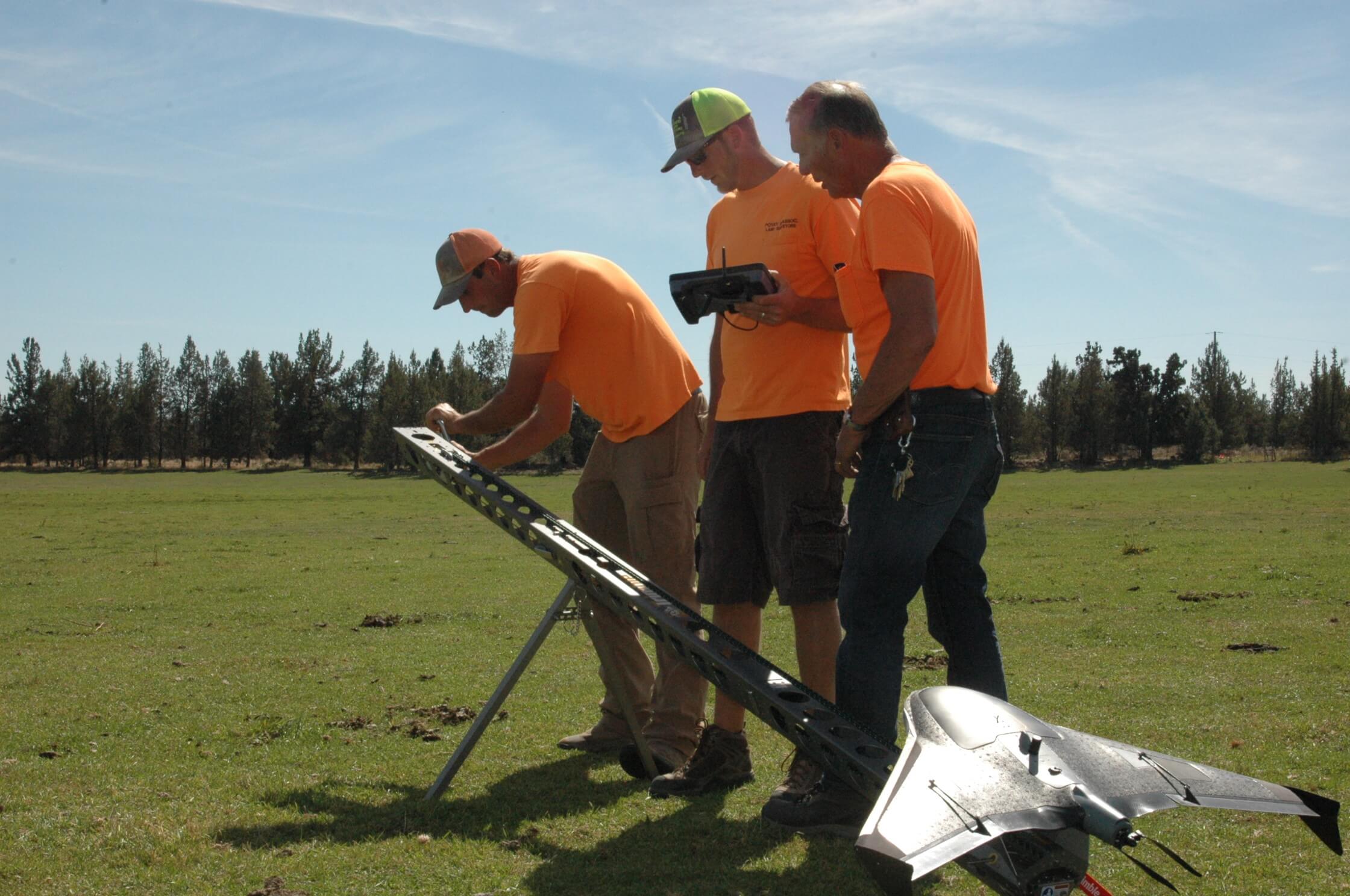 Povey field crew preparing a mapping drone for flight