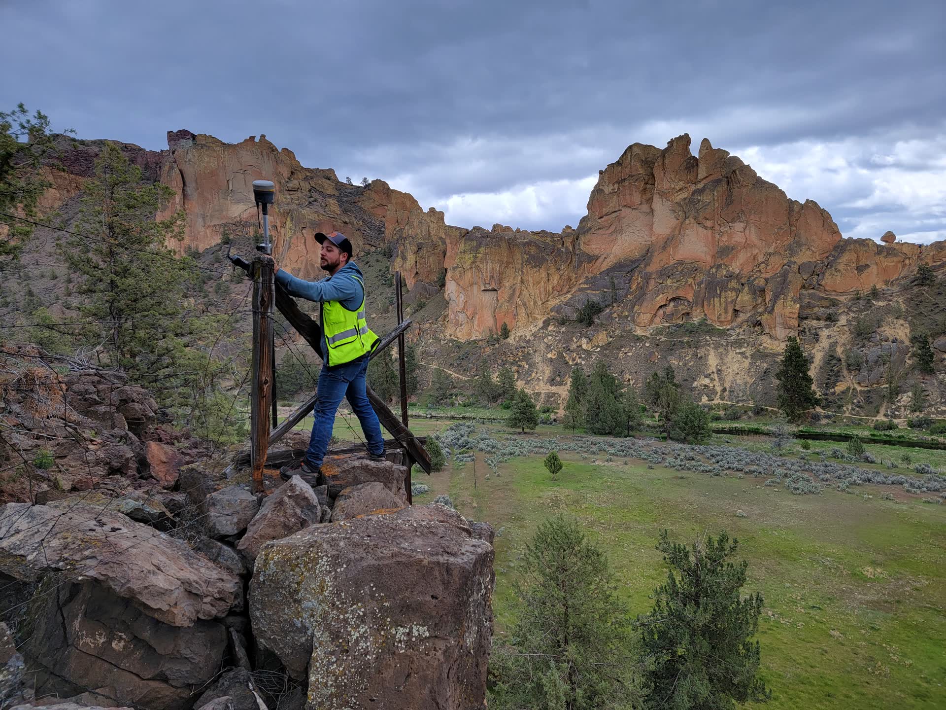 Povey surveyor measuring a site with GPS equipment beside a Central Oregon canyon