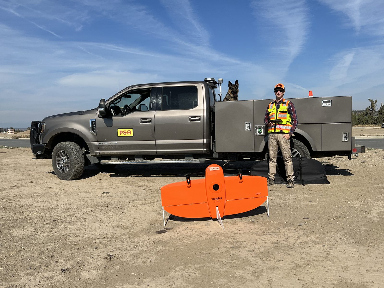 Povey crew member beside the survey truck with a WingtraOne mapping drone on a Central Oregon job site