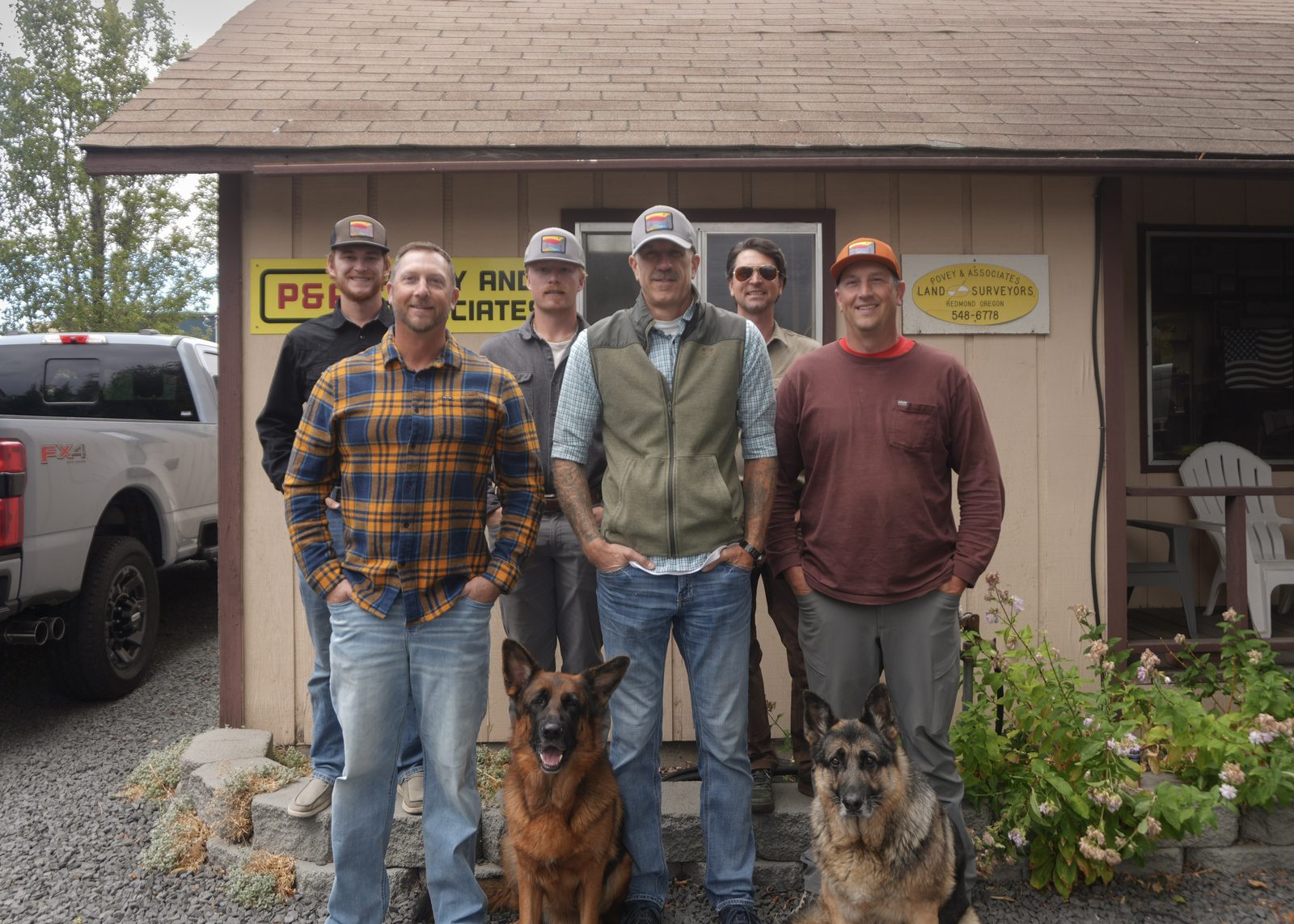 The Povey & Associates crew and their two dogs in front of the Redmond office